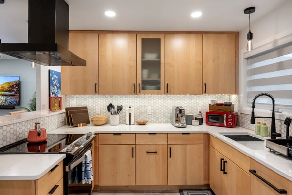 West Juneau Mountain-View Retreat kitchen with pale wood cabinetry and organized counters